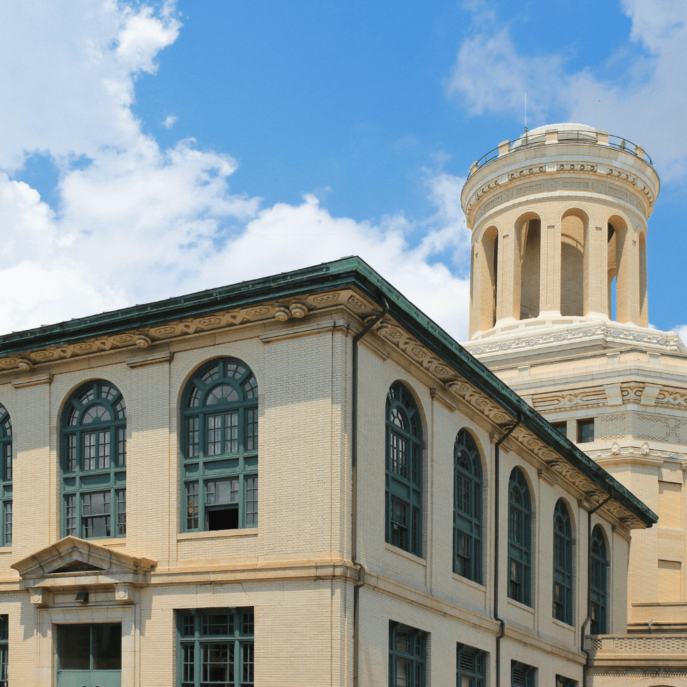 A building with a large tower in the background.