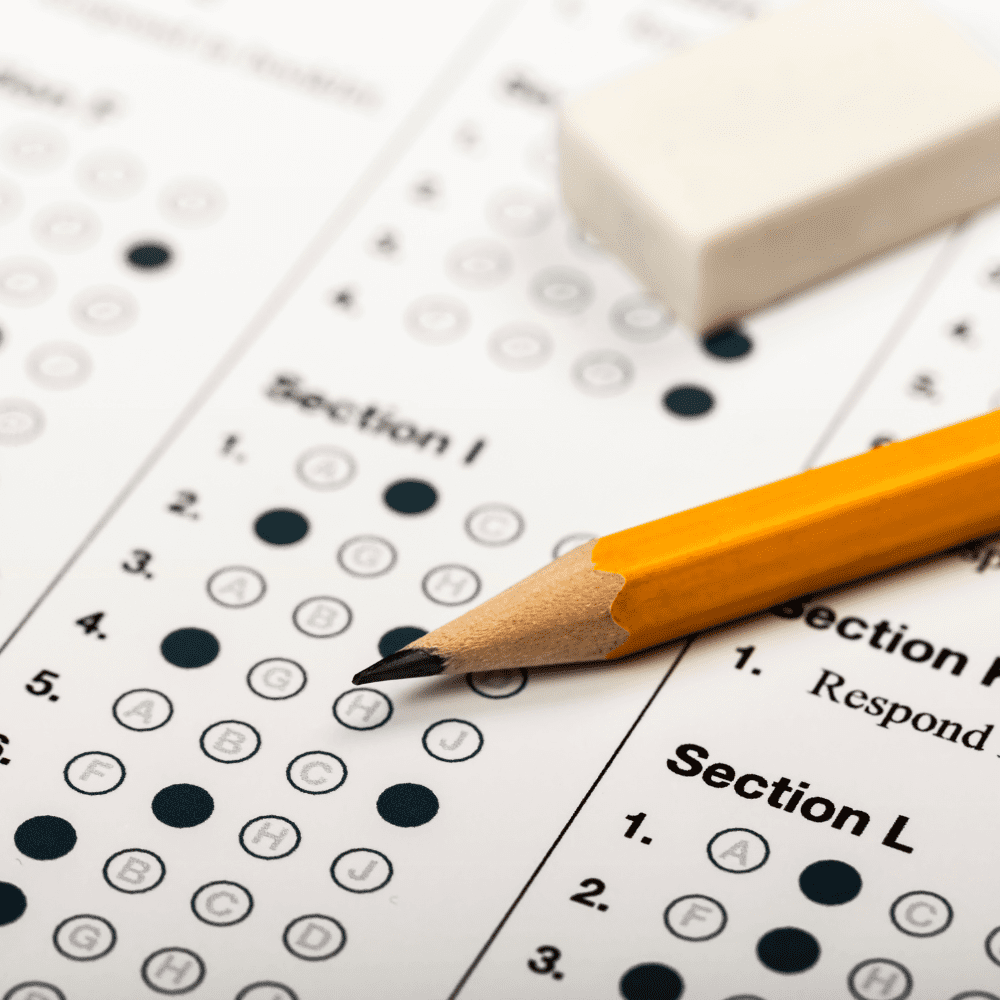 A pencil and eraser sitting on top of an exam sheet.