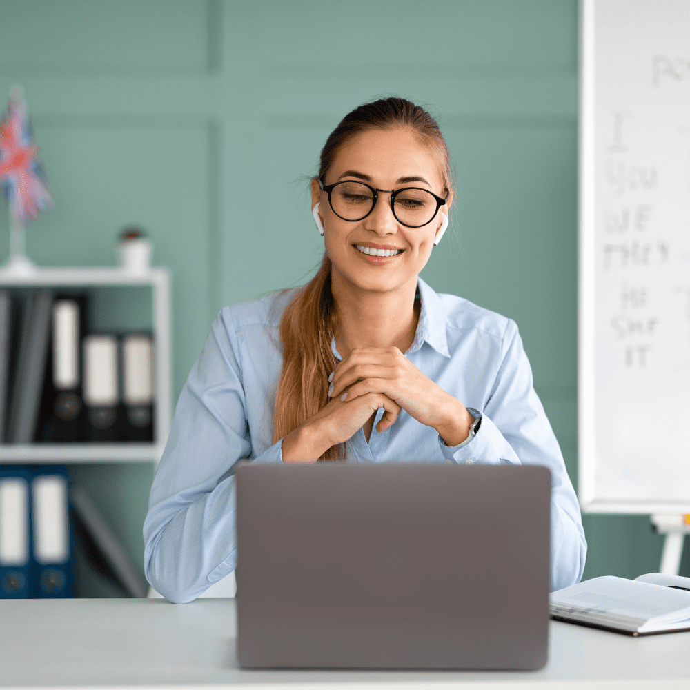 A woman sitting at her desk with a laptop.