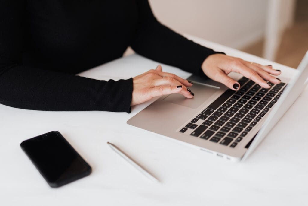 A person is typing on a laptop