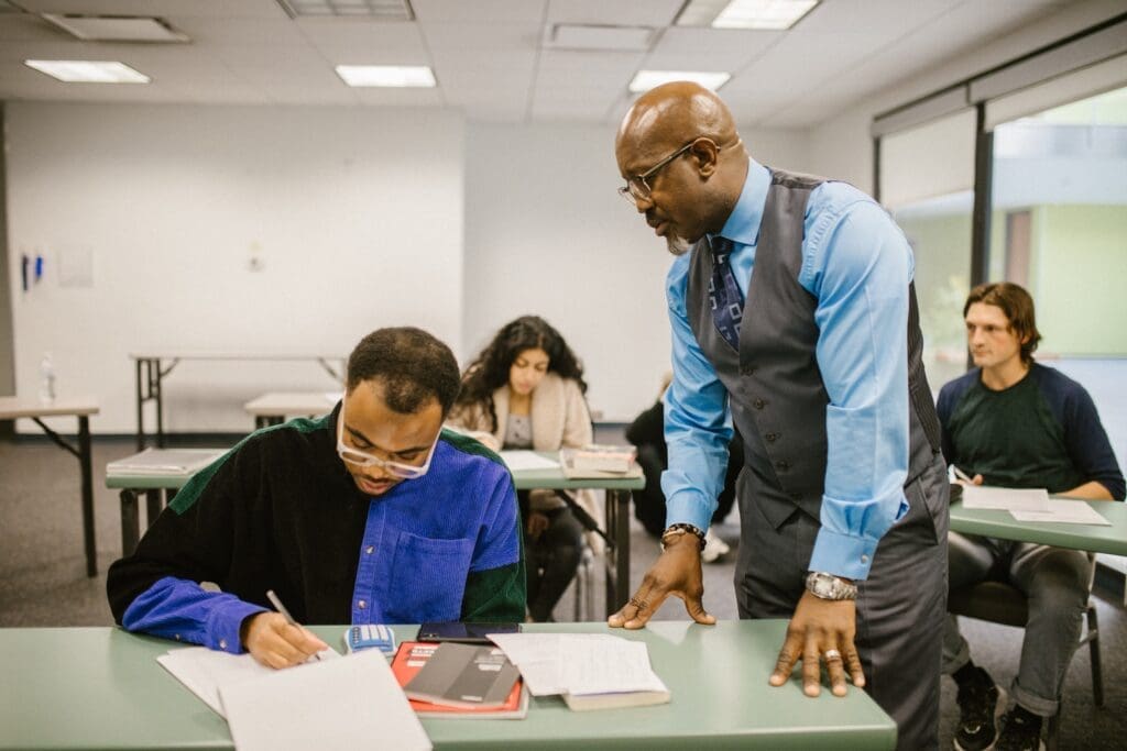 Two men are working on papers in an office.