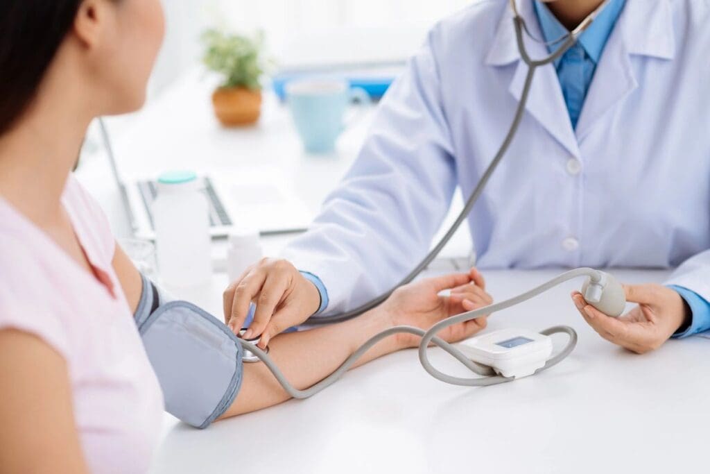 Doctor discussing blood pressure management with a female patient in an online education setting.