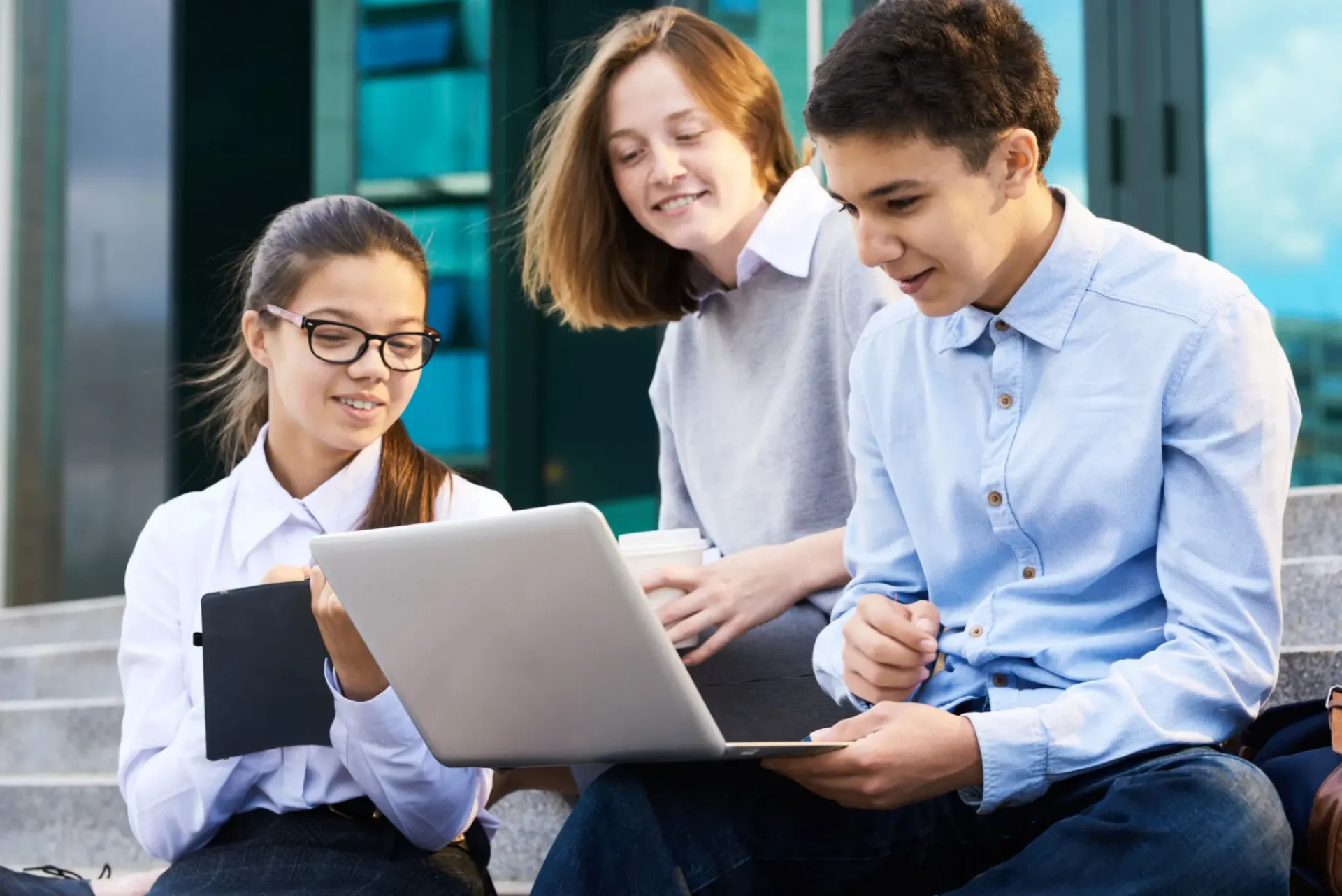 Teens using a laptop for a 
financial simulation